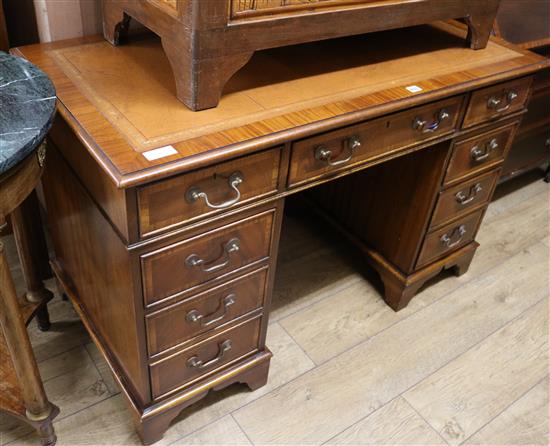 A George III style satinwood banded mahogany pedestal desk